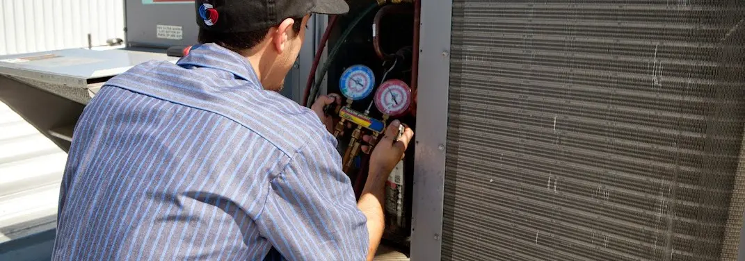 HVAC technician servicing a condenser unit in Gold River