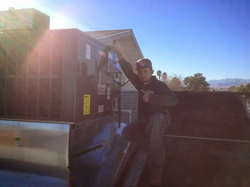 HVAC technician performing Boiler Repair on a rooftop unit in Gold River